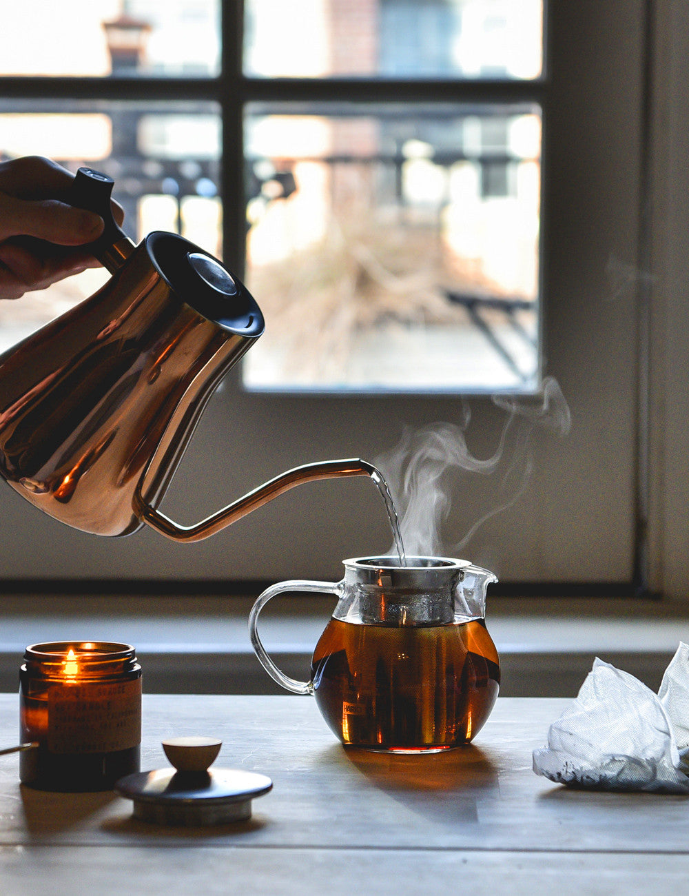 Front shot of someone pouring hot water into the Hario Teapot.